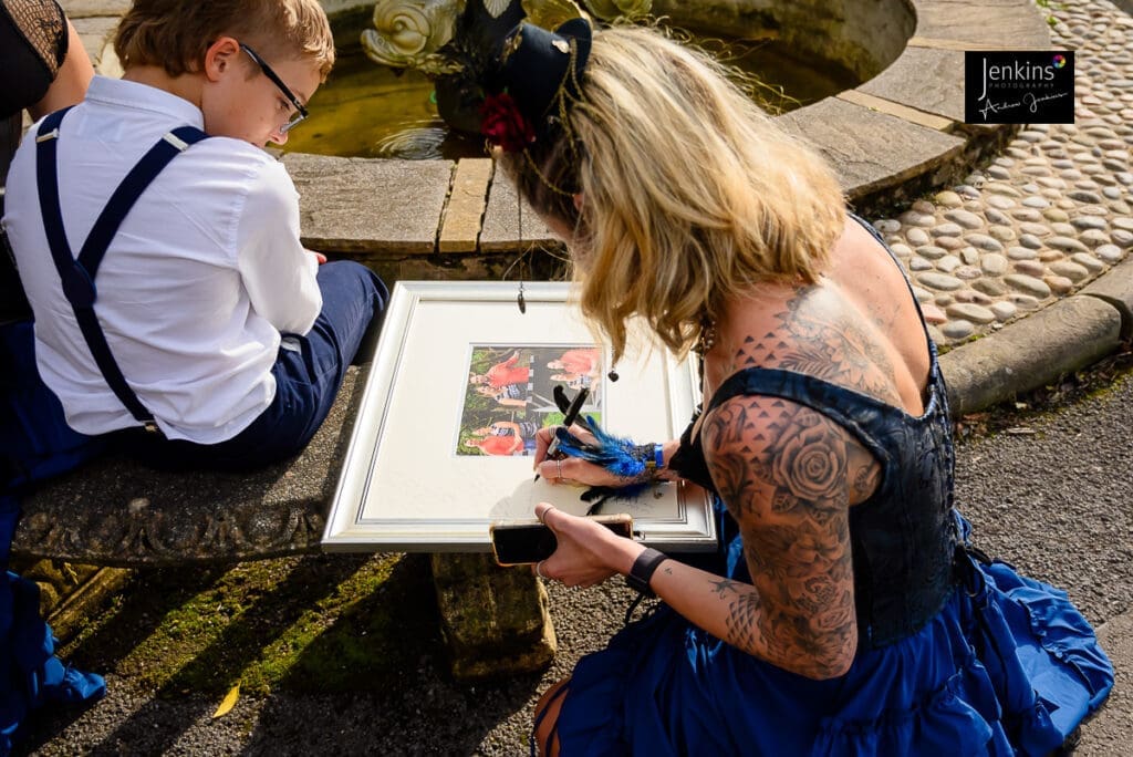 Guest signing our photo mount that all our wedding couples have Jenkins.photography