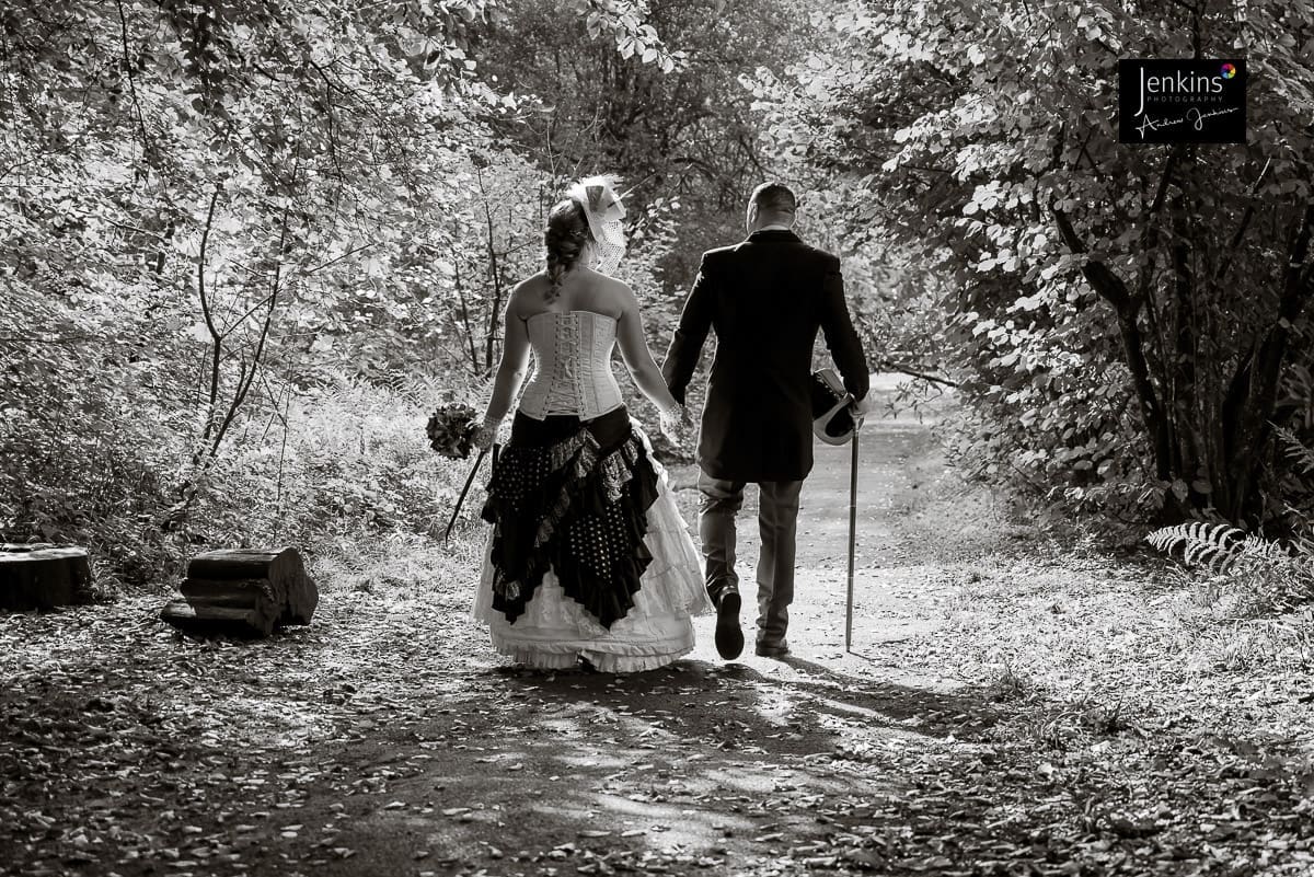 bride & Groom walking craig-y-nos-castle-steampunk-wedding-jenkins-photography
